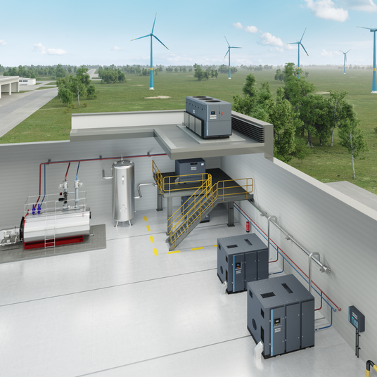 zoomed out view looking into an industrial setting showing the mixed view of air compressors and a chiller located on the roof.